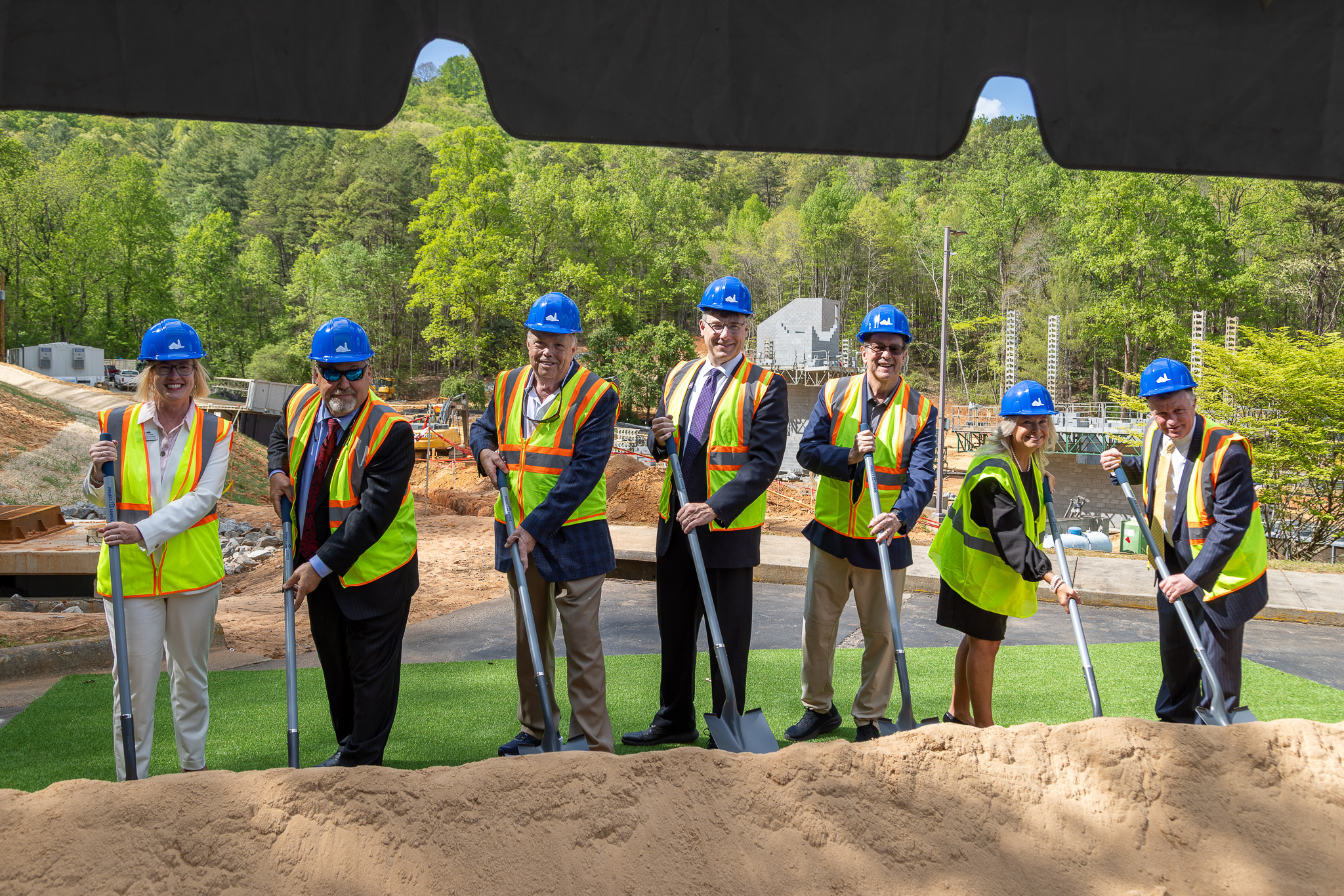 Groundbreaking attendees pose with shovels after ceremony