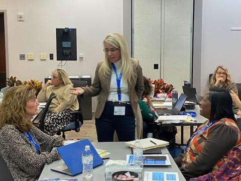 Literacy Leader Conference attendees talking with each other.